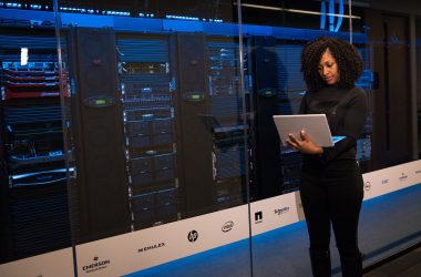pexels photo 1181354 1181354 A female engineer using a laptop while monitoring data servers in a modern server room.
